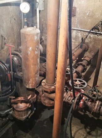 Deteriorated old piping for anaerobic digester equipment damaged by frequent flooding at a wastewater treatment facility in Savanna, Illinois.