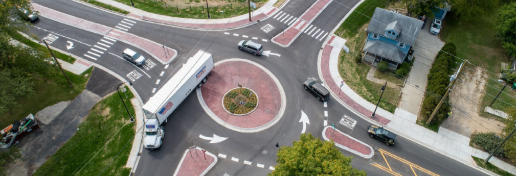 A mini-roundabout accommodates large truck patterns at the intersection of Baker Road and Dan Hoey Road in Dexter, Michigan.