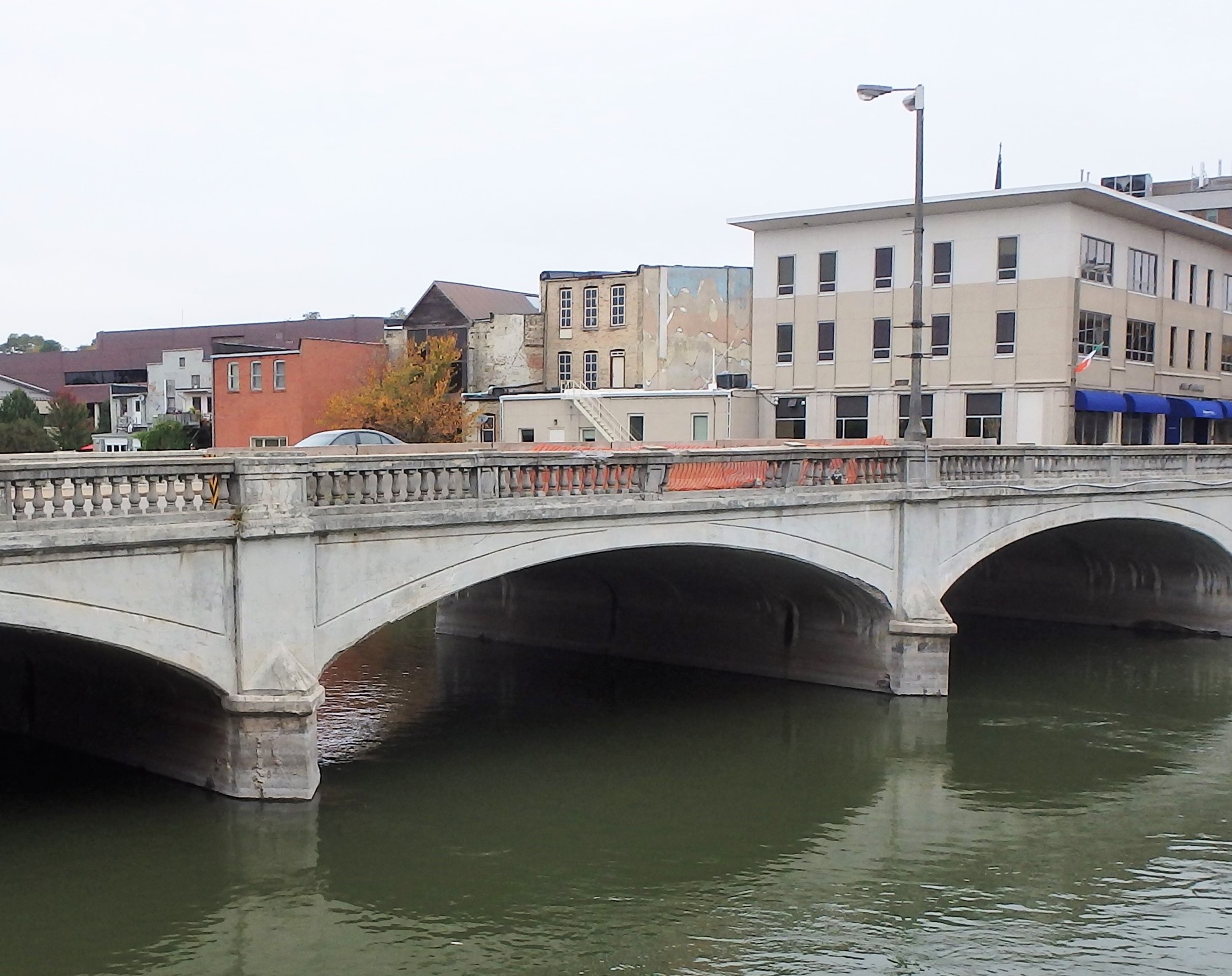 The former bridge across the Rock River in Janesville, Wisconsin, was severely deteriorating, with cracking and concrete falling into the river.