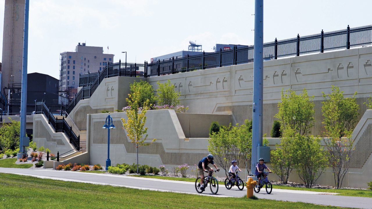 A large Sanitary Sewer Overflow Storage Facility in the heart of Duluth, Minnesota, is perfectly camouflaged beneath a new park-like plaza.