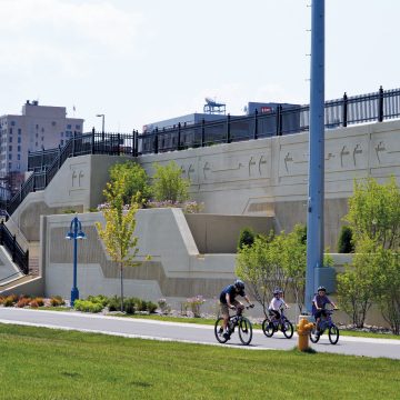 A large Sanitary Sewer Overflow Storage Facility in the heart of Duluth, Minnesota, is perfectly camouflaged beneath a new park-like plaza.
