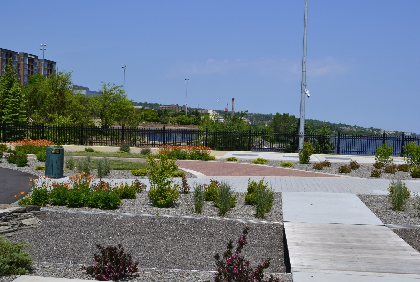 A large Sanitary Sewer Overflow Storage Facility in the heart of Duluth, Minnesota, is perfectly camouflaged beneath a new park-like plaza.