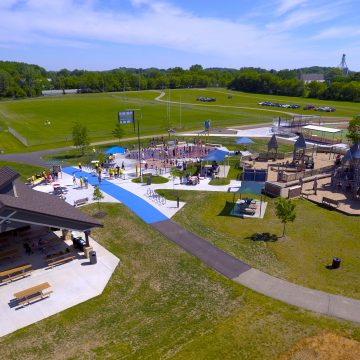 Aerial view of Bakken Park in Cottage Grove, Wisconsin, with new community splash pad, restroom and concessions building, ADA accessibility and connection to Miracle League Field.