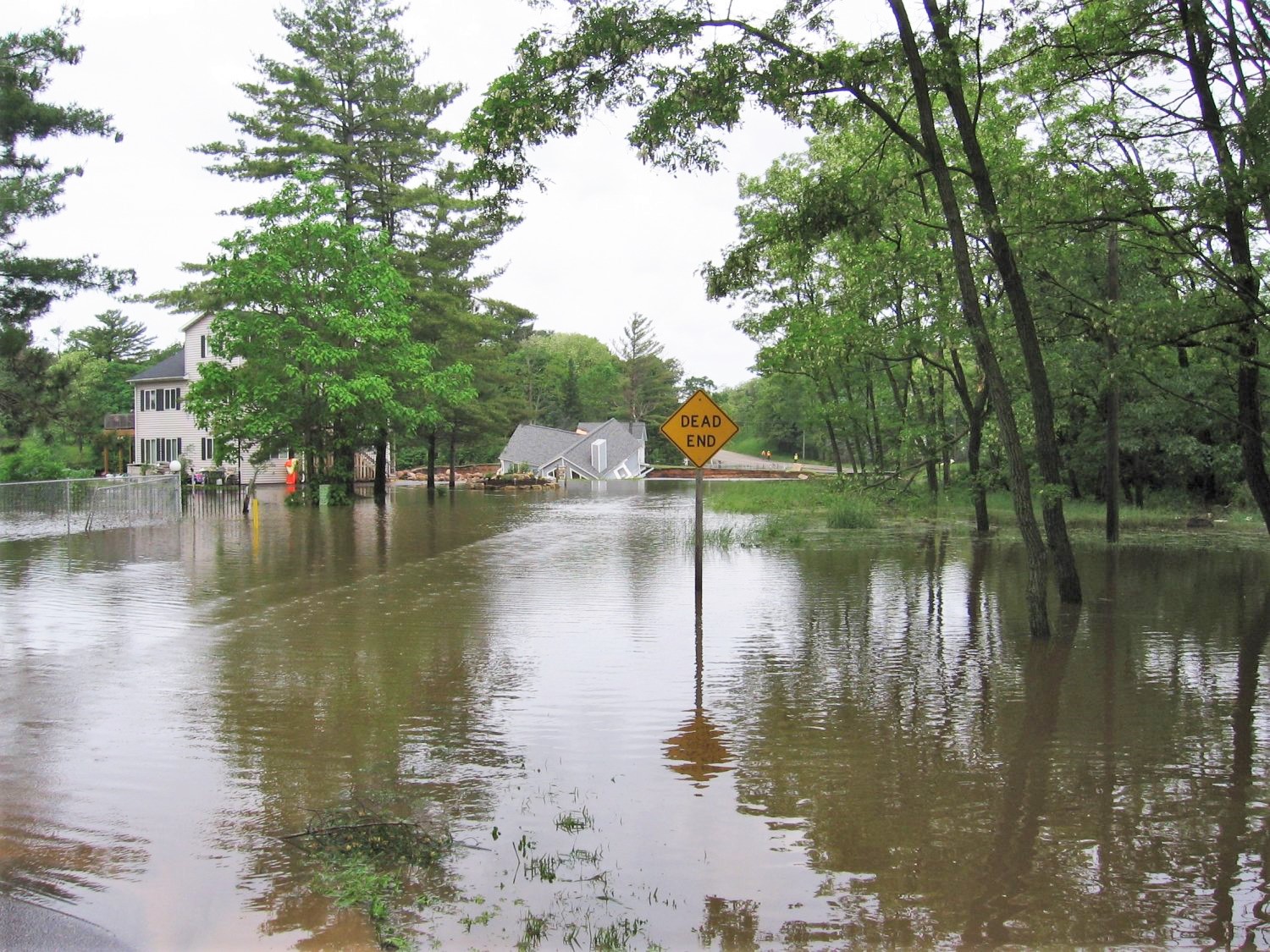 High flood waters destroy homes and streets