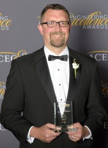 MSA Vice President of Building Services accepting an award for the Mount Carroll wastewater treatment facility at the ACEC national convention in 2022