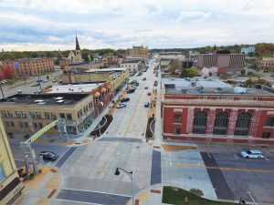 Aerial photograph of a newly reconstructed street in downtown Janesville, Wisconsin, with improved ADA compliance, updated streetscaping and places for resident gathering. 
