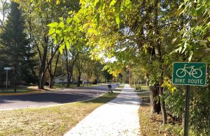 Photograph of a bike and pedestrian trail leading into a residential neighborhood.