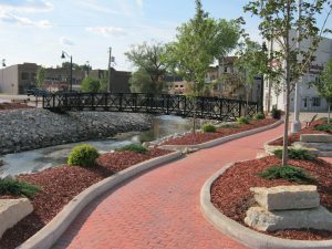 Image of a reconstructed new downtown riverwalk and pedestrian bridge after flooding events in Beaver Dam, Wisconsin.