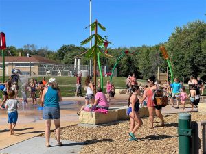 People of all ages enjoying a new splash pad in Reedsburg, Wisconsin.