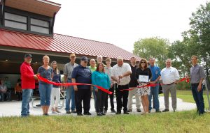 Photograph of Village elected officials, project stakeholders and local dignitaries at a ribbon-cutting ceremony for the new Forest Park in the Village West Baraboo Wisconsin. 